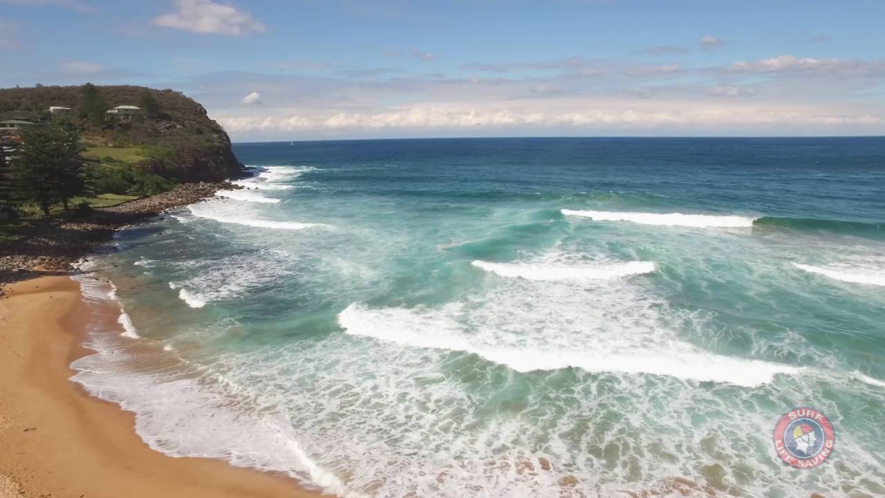 What is a rip current? Image of waves breaking on to a beach